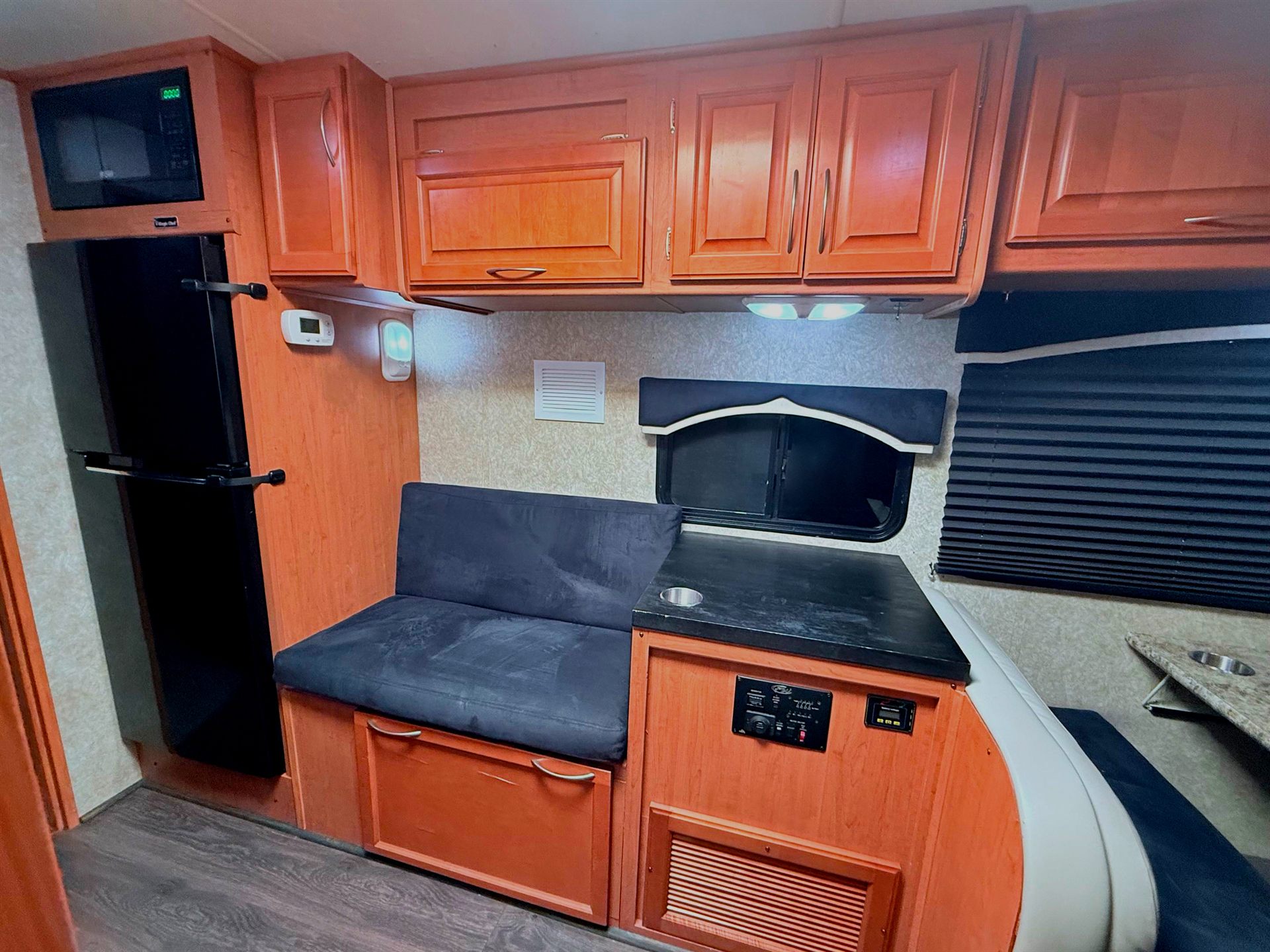 Galley with refrigerator, microwave and couch