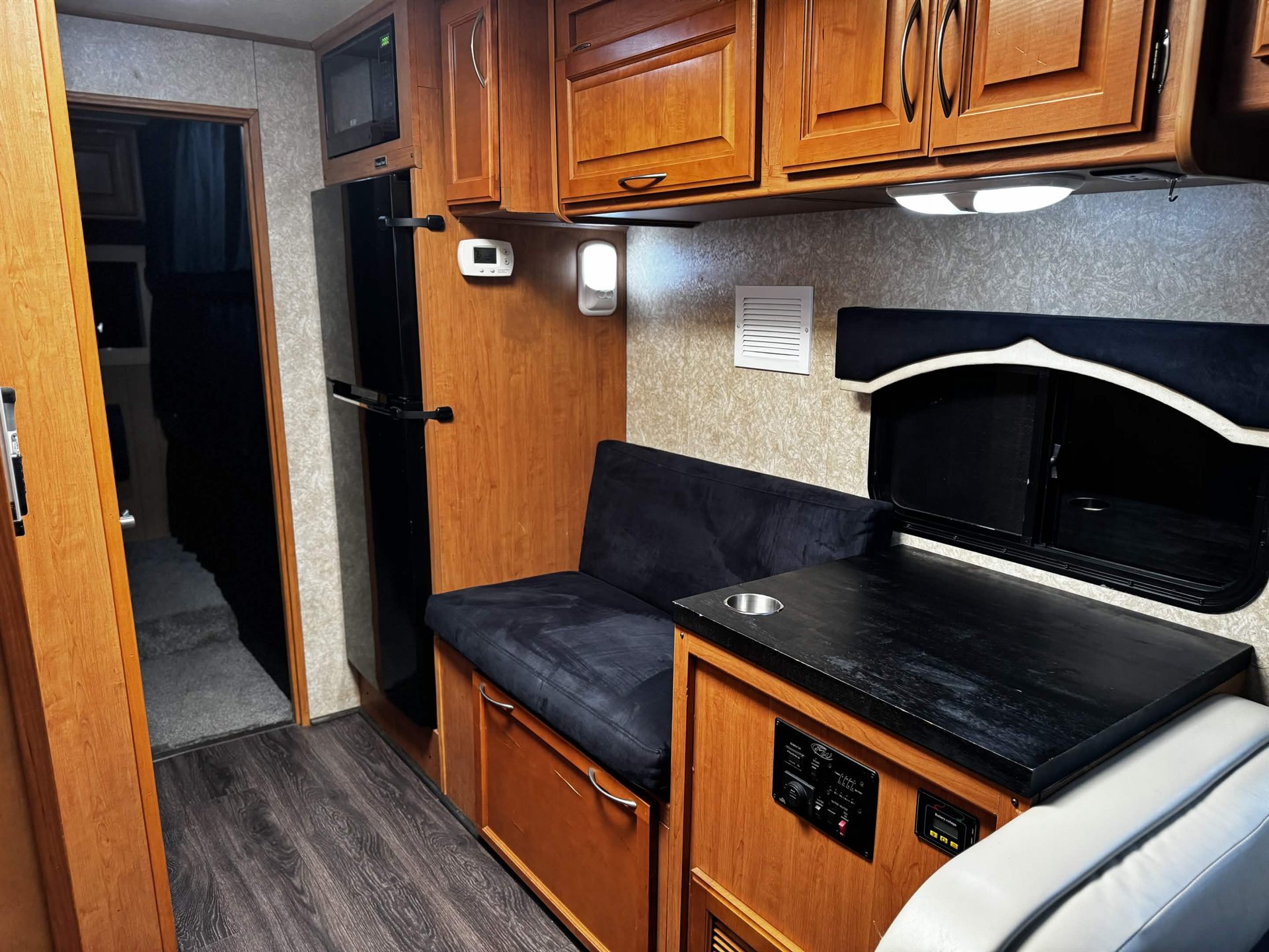 Kitchenette with refrigerator, microwave and couch
